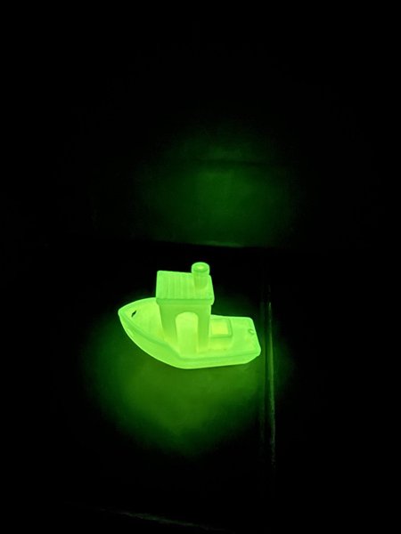 A benchmark print, a.k.a. "Benchy". Glowing in the dark.