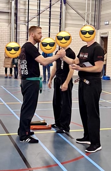 Photo of me receiving congratulations for passing the level test.