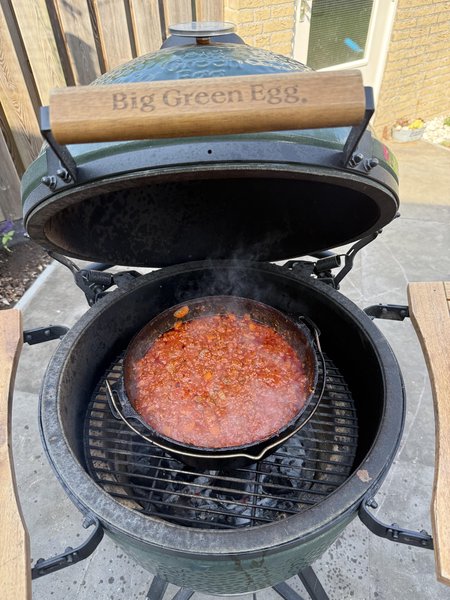 Photo of a kamado with a pot of sauce on it